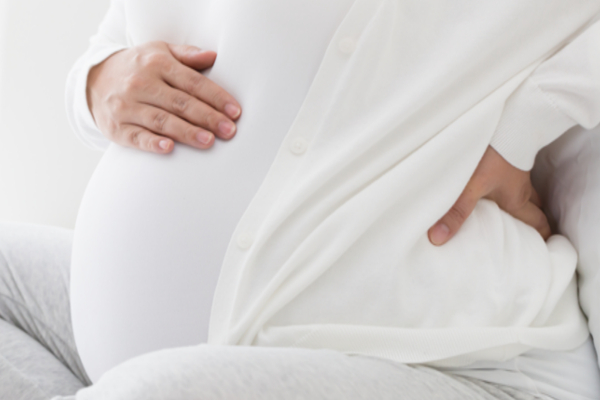 pregnant woman holding back