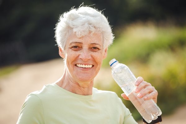 elderly woman drinking water