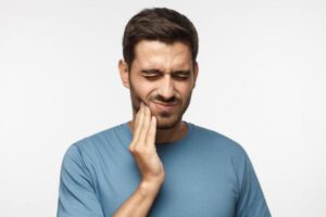 man suffering from jaw pain