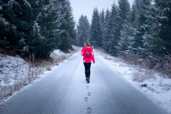 woman walking on snowy road